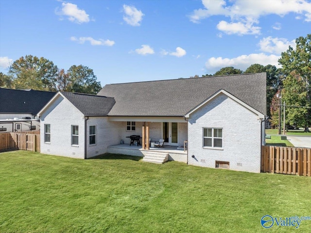 rear view of house with a yard and a patio