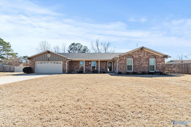 ranch-style home with a garage, brick siding, driveway, and fence