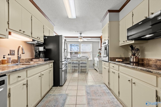 kitchen with ceiling fan, light tile patterned floors, cream cabinets, a sink, and black appliances