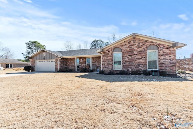 ranch-style house with an attached garage, board and batten siding, and brick siding