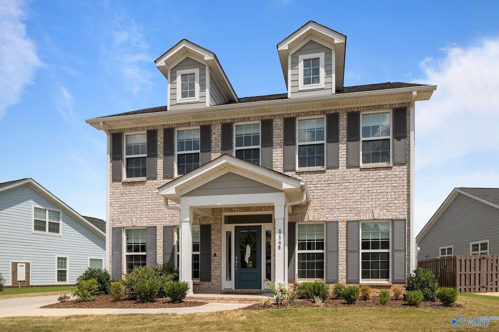 view of front of property with a porch and a front lawn