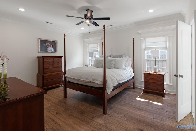 bedroom featuring crown molding, dark wood-type flooring, and ceiling fan