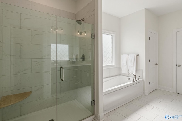 bathroom featuring separate shower and tub