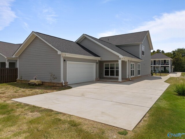 view of front facade with a garage and a front lawn