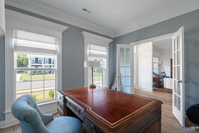 home office featuring hardwood / wood-style flooring, ornamental molding, and french doors