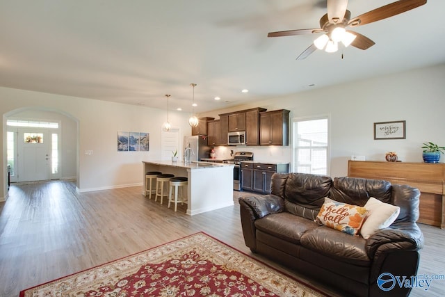 4304 Adventura Dr, Owens Cross Roads, AL 35763 - living area with arched walkways, a ceiling fan, light wood-style flooring, recessed lighting, and baseboards