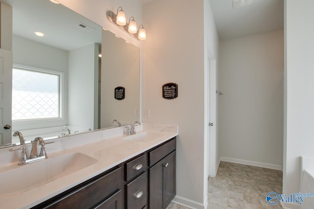 4304 Adventura Dr, Owens Cross Roads, AL 35763 - full bath with a tub, double vanity, and baseboards