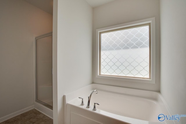 4304 Adventura Dr, Owens Cross Roads, AL 35763 - full bathroom with plenty of natural light, a shower stall, and a garden tub