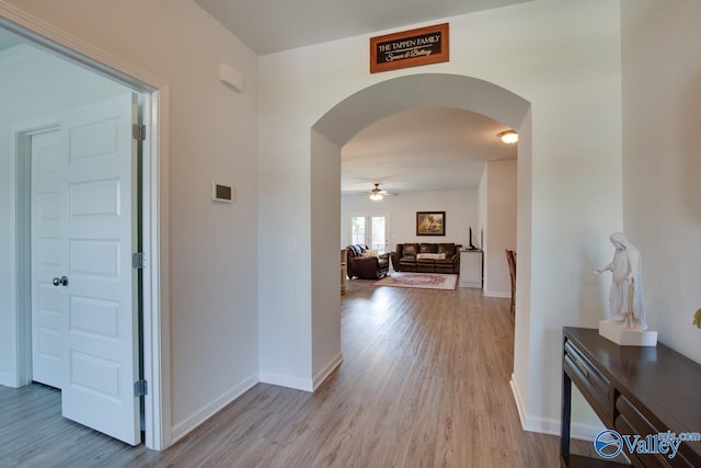 4304 Adventura Dr, Owens Cross Roads, AL 35763 - corridor with arched walkways, light wood-style flooring, and baseboards