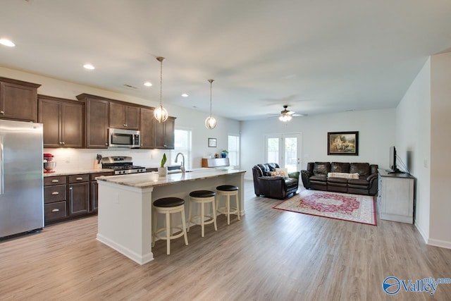 4304 Adventura Dr, Owens Cross Roads, AL 35763 - kitchen with stainless steel appliances, dark brown cabinets, light wood-style flooring, a ceiling fan, and recessed lighting