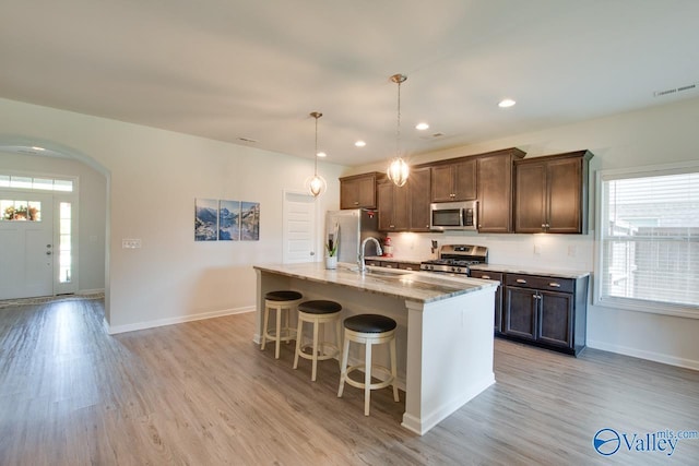 4304 Adventura Dr, Owens Cross Roads, AL 35763 - kitchen featuring appliances with stainless steel finishes, plenty of natural light, light wood finished floors, a kitchen breakfast bar, and recessed lighting