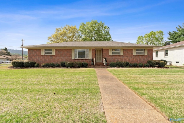 ranch-style house with brick siding and a front yard