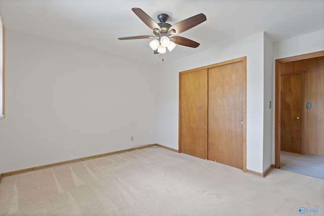 unfurnished bedroom with baseboards, a closet, a ceiling fan, and light colored carpet
