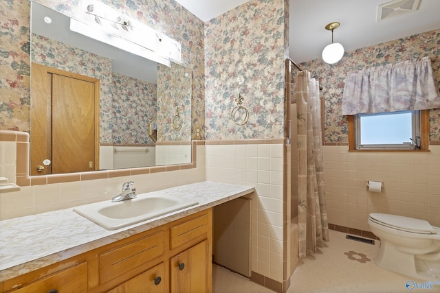 full bath featuring wallpapered walls, visible vents, toilet, tile walls, and wainscoting