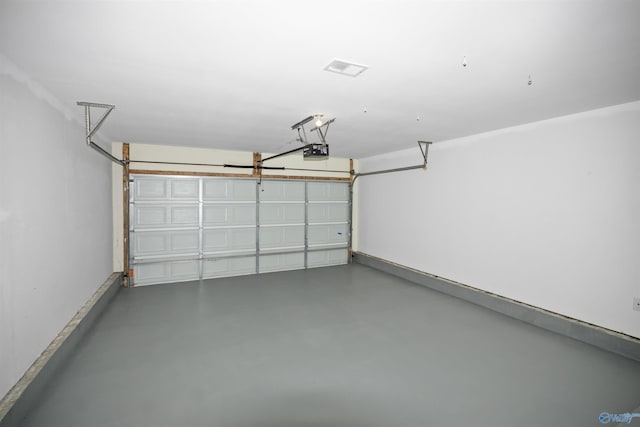 garage featuring a garage door opener and baseboards