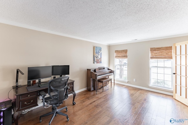 office area with a textured ceiling, wood finished floors, and crown molding