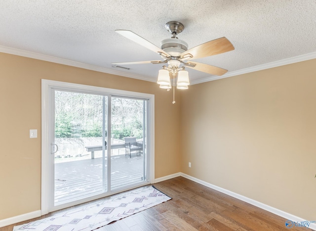 unfurnished room featuring a textured ceiling, ornamental molding, light wood-style flooring, and baseboards