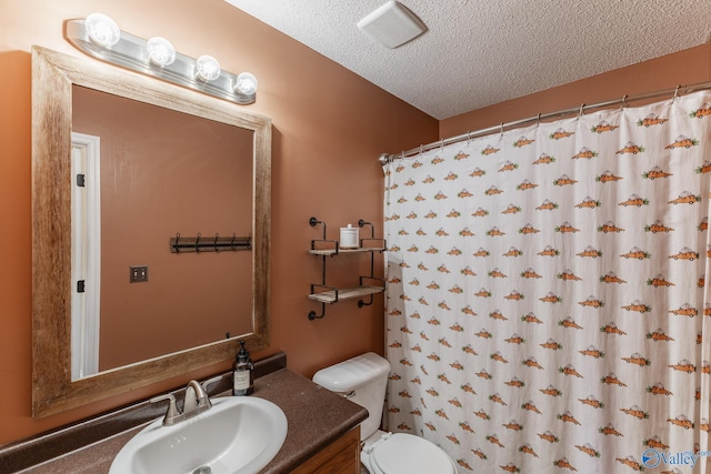 bathroom featuring toilet, visible vents, a textured ceiling, and vanity