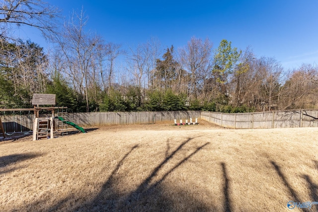 view of yard featuring a playground and fence