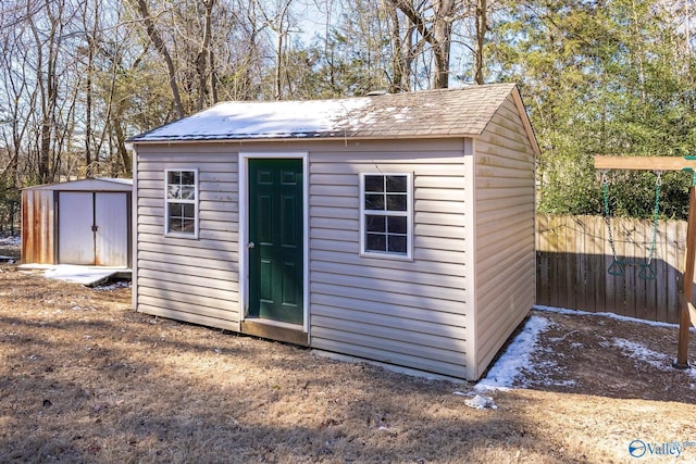 view of shed with fence