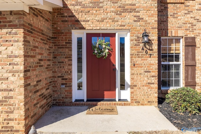 doorway to property with brick siding