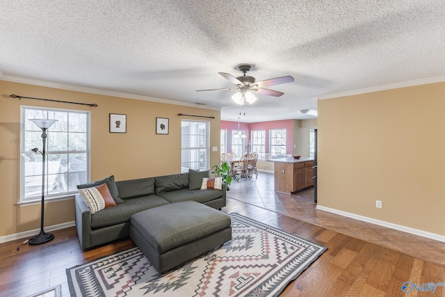 living area with dark wood-style floors, a textured ceiling, a ceiling fan, and crown molding