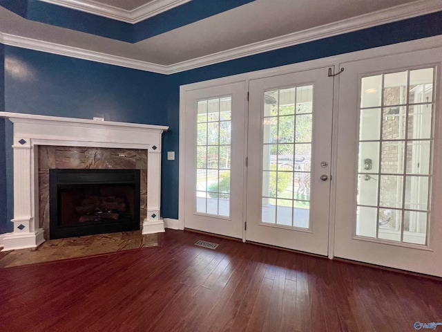 doorway to outside with a fireplace, dark hardwood / wood-style flooring, and ornamental molding
