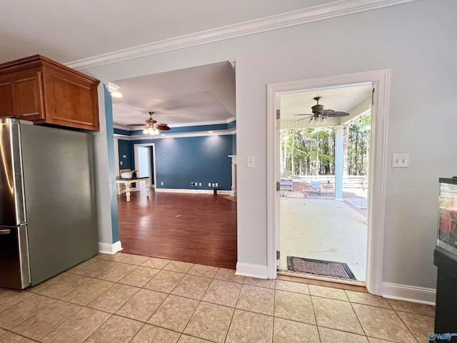 kitchen with ornamental molding, light hardwood / wood-style flooring, ceiling fan, and stainless steel fridge