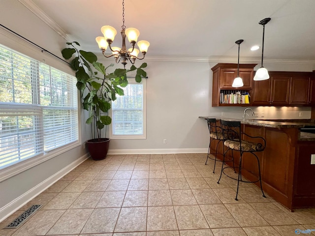 kitchen featuring pendant lighting and ornamental molding