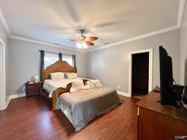 bedroom featuring dark wood-type flooring, ornamental molding, a walk in closet, and ceiling fan
