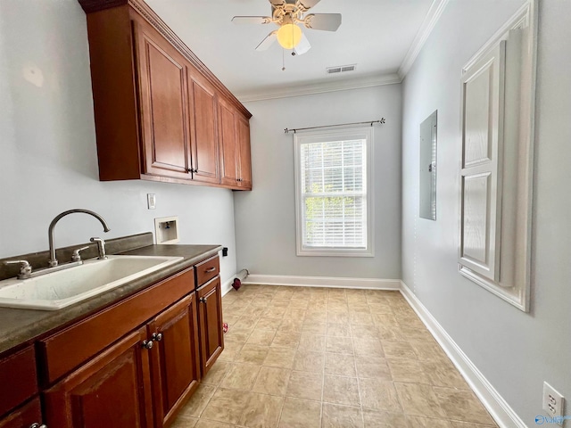 washroom with electric panel, cabinets, sink, ornamental molding, and washer hookup