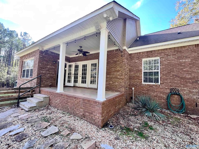 view of side of property with french doors, ceiling fan, and a patio area