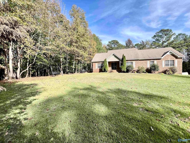 single story home featuring a front lawn