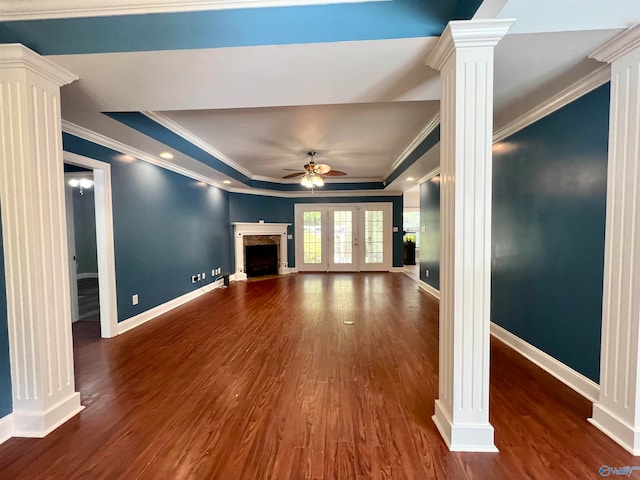 unfurnished living room with decorative columns, ornamental molding, dark hardwood / wood-style floors, a raised ceiling, and ceiling fan