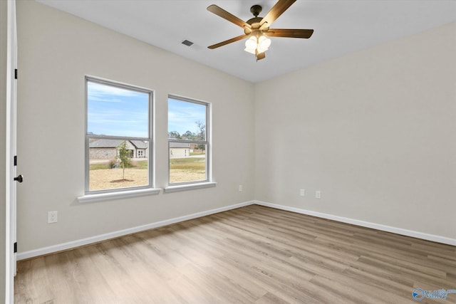 empty room featuring light wood-type flooring and ceiling fan