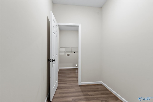 corridor with dark hardwood / wood-style flooring