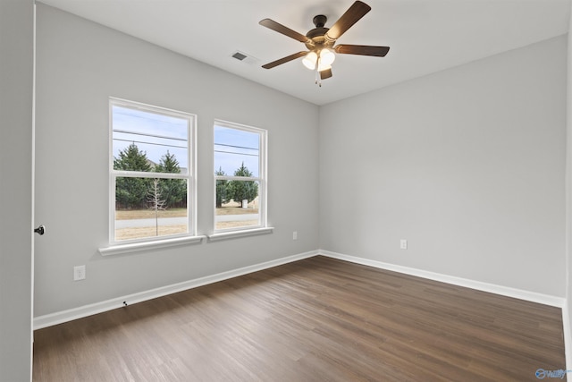 unfurnished room with ceiling fan and dark hardwood / wood-style floors