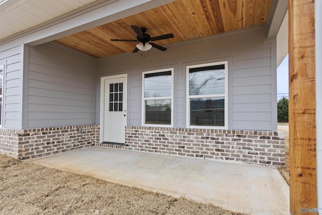 doorway to property with ceiling fan and a patio