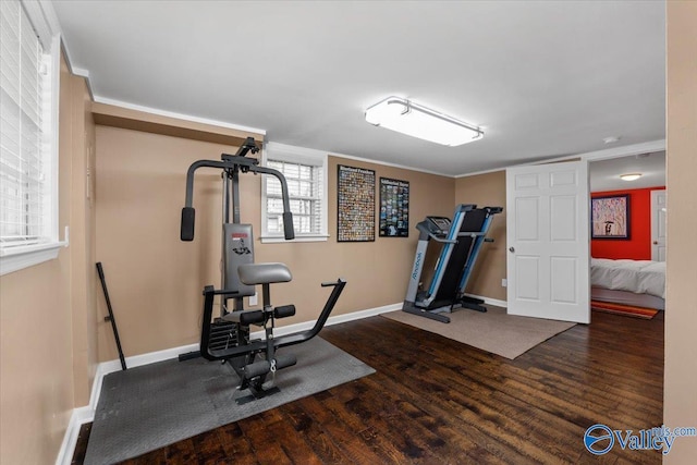 workout room featuring wood finished floors and baseboards