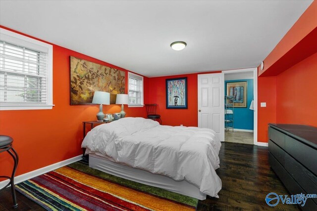 bedroom featuring baseboards and wood finished floors