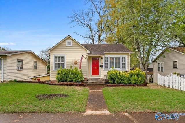 view of front of property with a front yard and fence