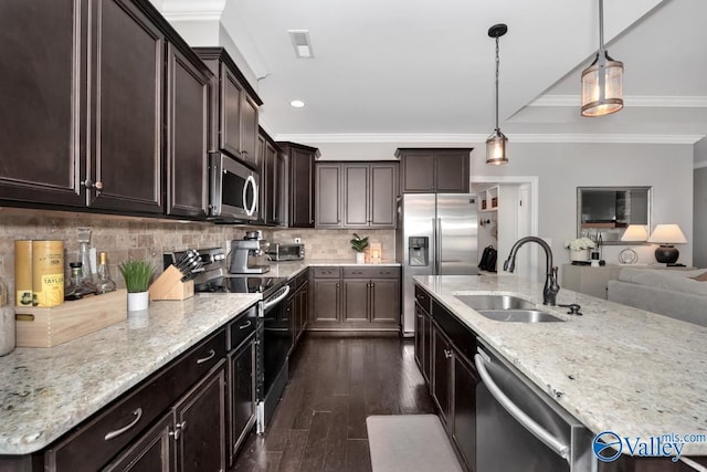 kitchen featuring sink, decorative backsplash, ornamental molding, decorative light fixtures, and stainless steel appliances