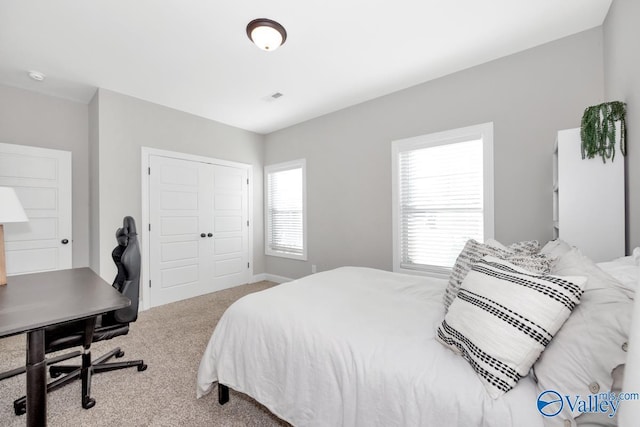 carpeted bedroom with a closet