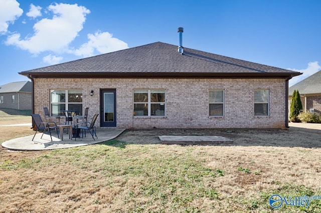 back of property featuring a lawn and a patio area