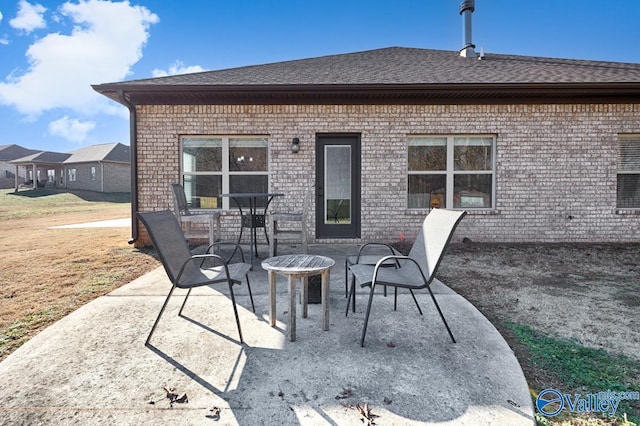 rear view of house featuring a yard and a patio area