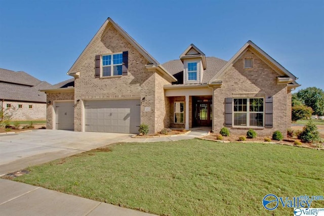 view of front of home with a garage and a front yard