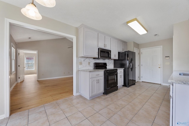 kitchen with white cabinetry, black appliances, light tile patterned floors, and tasteful backsplash