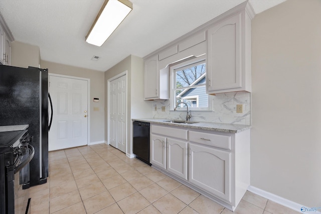 kitchen with visible vents, black appliances, a sink, tasteful backsplash, and light tile patterned floors