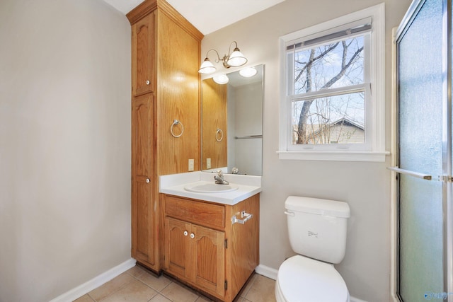 bathroom featuring tile patterned floors, toilet, vanity, and baseboards