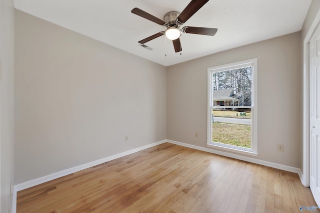 empty room with ceiling fan, baseboards, visible vents, and light wood-type flooring